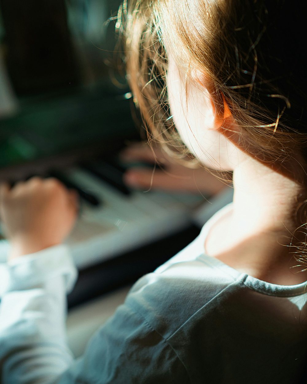 child-playing-piano-andrey-k-unsplash